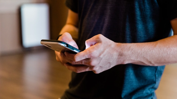 Man typing on his mobile phone.